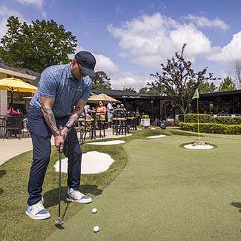 Sink a putt on the Club Magnolia Greens three hole putting course, hosted by the Club Magnolia Girls.