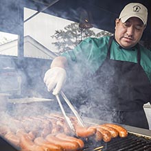 Dogs on the grill at the Club Magnolia Burger Bar & Grill